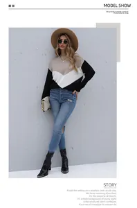 Fashionable color-block long sleeve sweater styled with a hat and chain shoulder bag