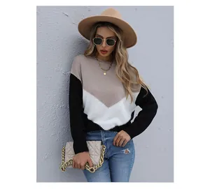 Detail of the knit texture and color-block pattern on the long sleeve sweater