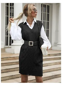 Detail of V-neck cable knit vest dress with thick texture and stylish black knitted pattern