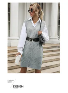 Detail of light blue diamond pattern knitted vest dress styled with an elegant pearl belt