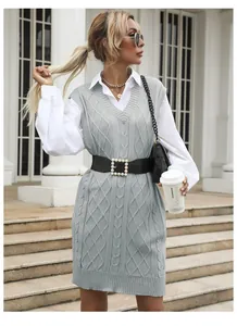 Detailed knit texture and deep V-neck of a gray sleeveless cable knit midi dress