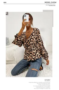 Detail of leopard print V-neck blouse with elastic waist and long sleeves on a model