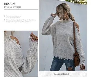 Detail showing distressed cold-shoulder design and speckled knit texture on high neck sweater