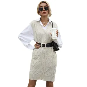 Women's V-neck cable knit vest dress in beige styled with a black pearl belt