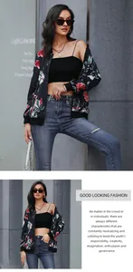 Detailed view of floral baseball jacket paired with black crop top and distressed blue jeans