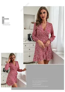 Detailed view of the V-neck wrap design and ruffled hem on this red floral mini dress