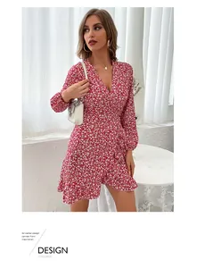 Macro view of red floral wrap dress with deep V-neck, ruffled hem and long sleeves