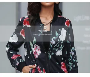 Close-up of the black floral print bomber jacket featuring red flowers and a front zipper