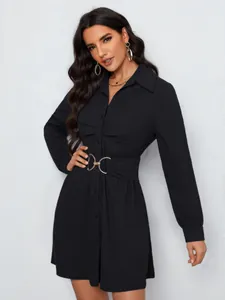 Detailed view of long sleeve shirt dress featuring a gold buckle waist belt and lapel