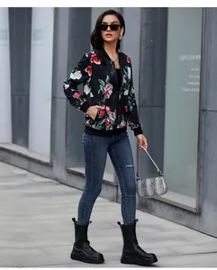Close-up of floral print bomber jacket with black ribbed cuffs and zipper closure