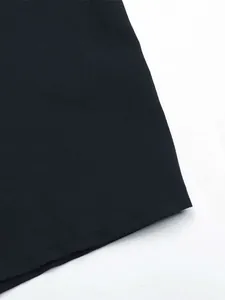 Close-up of black shirt dress fabric showing high-quality woven texture and neat stitching