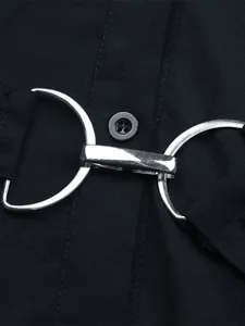 Detailed macro view of black fabric with silver horsebit buckle and round button