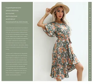 Detail of green floral pleated dress featuring a tie waist and delicate ruffled sleeves