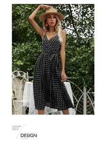Detail of V-neckline and adjustable waist tie on black polka dot chiffon midi dress