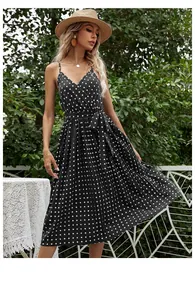 Detail of V-neck chiffon polka dot pleated dress with a stylish waist tie for summer