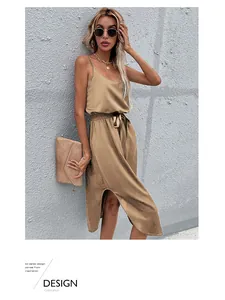 Detail of khaki satin midi dress showing the side slit and waist tie on the fabric
