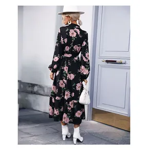 Vue arrière d'une robe noire à manches longues avec motifs floraux et ourlet volanté