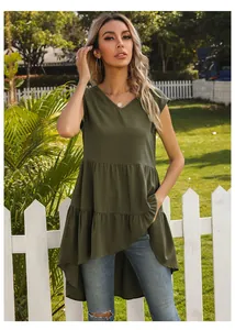 Detail of dark green sleeveless V-neck top with layered ruffle hem and high-low cut