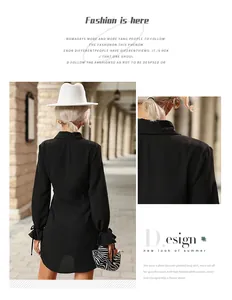 Détail d'une robe chemise noire courte avec manches plissées et liens élégants aux poignets