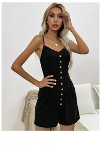 Detail view of black summer romper with spaghetti straps, V-neck, and button-front design