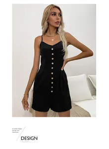 Detail of black summer romper with textured fabric, button-up front, and slim straps