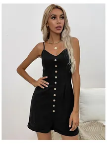 Close-up of black sleeveless romper featuring front buttons and rolled hems on soft fabric