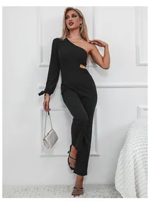 Detail of black one-shoulder jumpsuit featuring waist cutout and side tie sleeve decoration