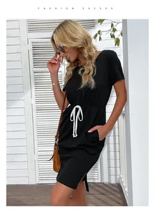 Detail of black T-shirt dress with white waist drawstring and side slit design