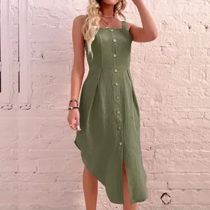 Green sleeveless linen dress with buttons and asymmetrical hem on a model background