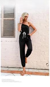 Detail eines schwarzen One-Shoulder-Jumpsuits mit verstellbarem weißen Kordelzug
