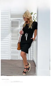 Detail of black slim fit T-shirt dress featuring a contrast white drawstring waist tie