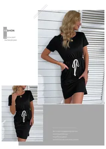 Detail view of black T-shirt dress featuring white drawstring waist and side pockets