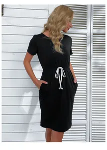 Detail of the waist drawstring and side pockets on a slim fit black t-shirt dress