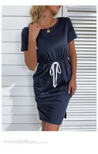 Detail of summer navy short sleeve dress with white woven drawstring waist and textured fabric