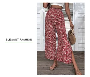 Detail of high waist red floral wide leg trousers with side slit for summer style