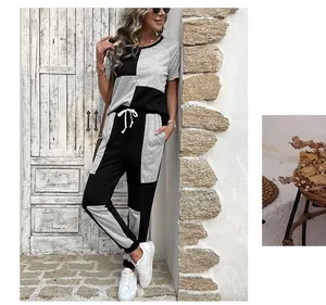 Detail of color-block knit set showing grey and black patchwork and drawstring waist