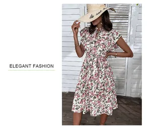 Detailed close-up of a floral summer dress with ruffle sleeves and elegant neck tie