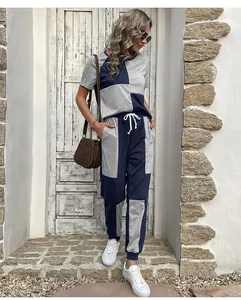Detailed view of color block leisure set featuring navy blue and grey stitching design