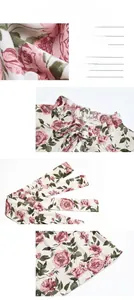 Detail of floral print dress showing ruffled stand collar with bow tie and fabric texture