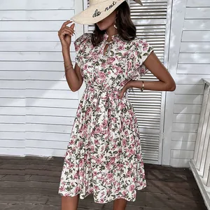 Floral print summer dress with flutter sleeves and belted waist on outdoor patio