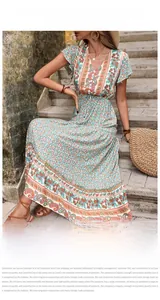 Detail of bohemian green floral maxi dress with V-neck, buttons and butterfly sleeves