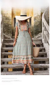Detail of bohemian floral paisley print dress with V-neck and tiered skirt for summer
