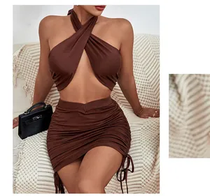Detail of dark brown two-piece set featuring halter neck top and side drawstring ruched skirt