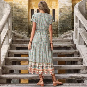 Bohemian floral maxi dress in green with high waist and flutter sleeves, rear view