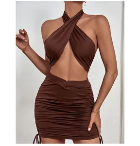 Detail of side drawstring and ruched texture on a brown mini skirt and halter set