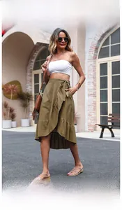 Detailed view of the ruffle hem and side pocket on this olive green linen wrap skirt