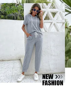 Detail of grey casual two-piece set featuring hooded short sleeve top and drawstring jogger