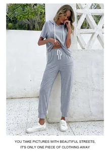 Detail of grey short sleeve hoodie set with white drawstring and matching joggers