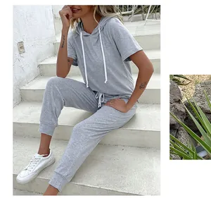 Detail of grey short sleeve hoodie and joggers set with white drawstrings on a model