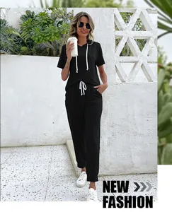 Detail of black short sleeve hoodie set with white contrast drawstrings and jogger pants